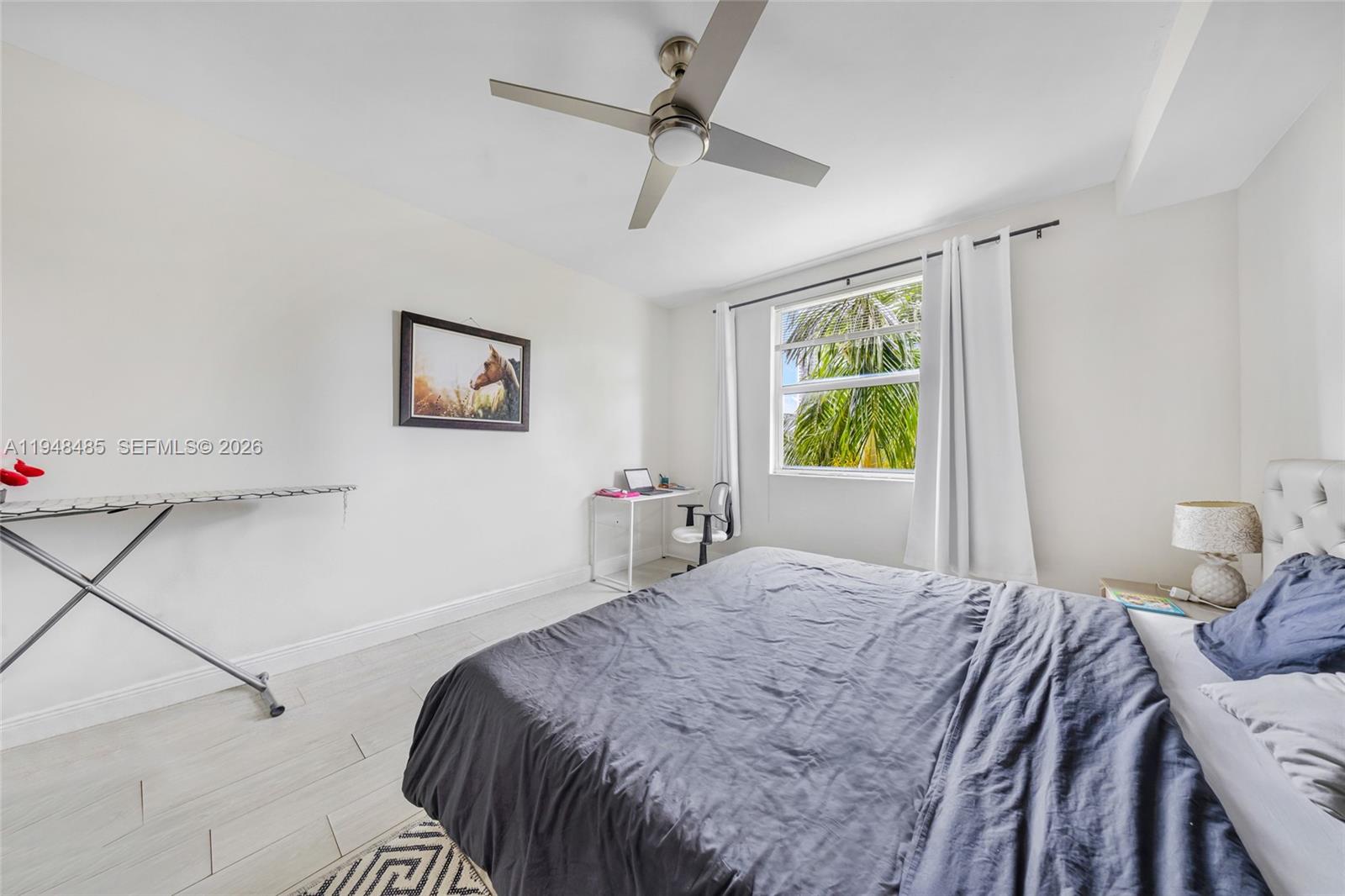 17145 North Bay Road, Unit 4506 Sunny Isles Beach, FL 33160 - Photo 4 of 10 a bedroom with a bed and a chandelier