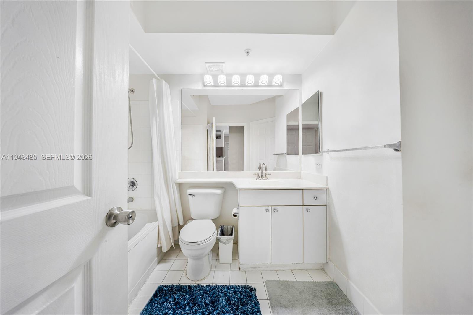 17145 North Bay Road, Unit 4506 Sunny Isles Beach, FL 33160 - Photo 5 of 10 a bathroom with a sink a toilet and a mirror