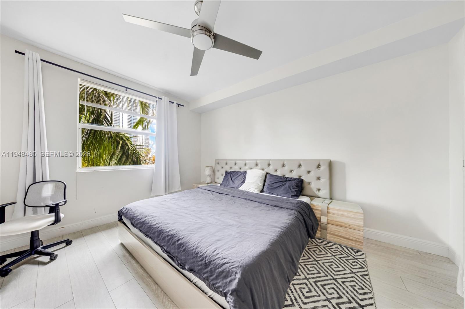 17145 North Bay Road, Unit 4506 Sunny Isles Beach, FL 33160 - Photo 6 of 10 a bedroom with a large bed and a window