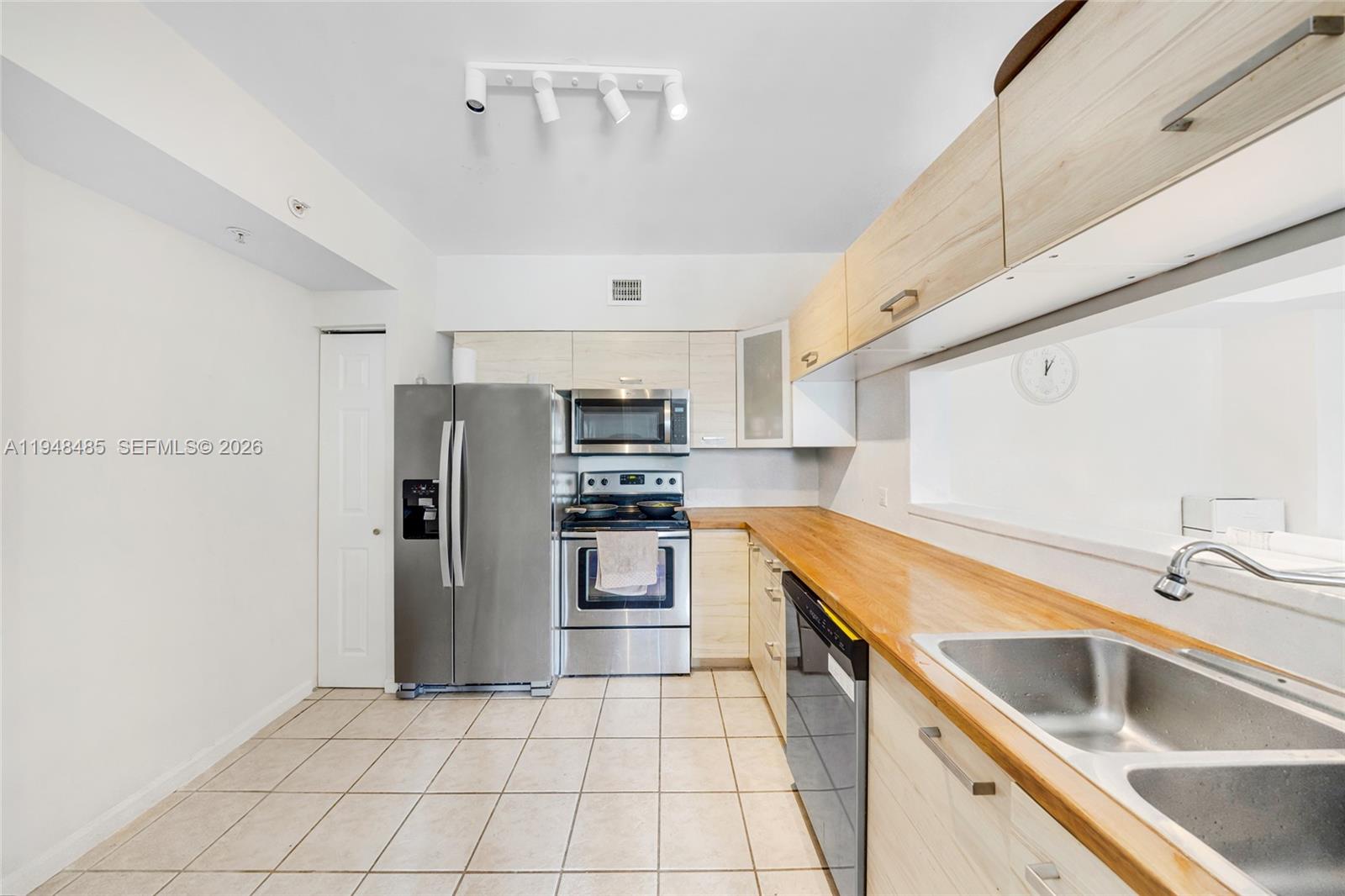 17145 North Bay Road, Unit 4506 Sunny Isles Beach, FL 33160 - Photo 8 of 10 a kitchen with stainless steel appliances granite countertop a sink and a refrigerator