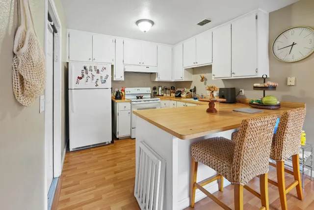 a kitchen with cabinets appliances and a sink
