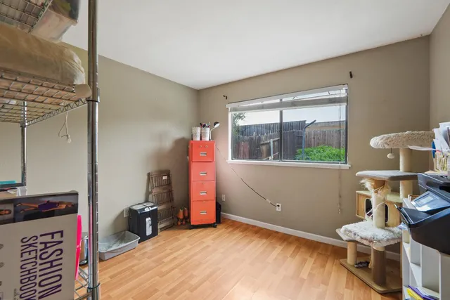 a room with a wooden floor and shoes