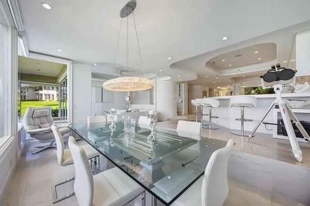 a view of a patio with lawn chairs floor to ceiling window and yard