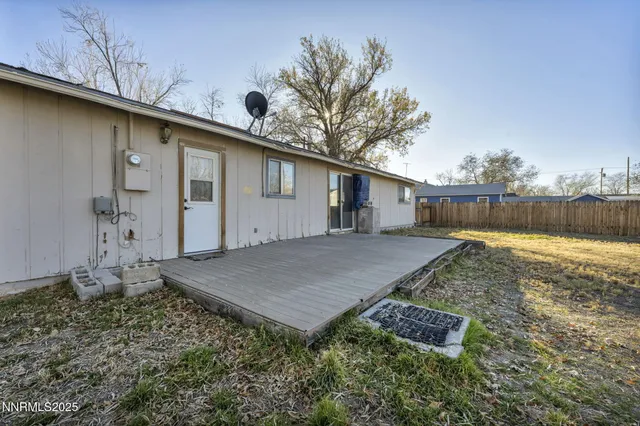 a view of yard with wooden fence