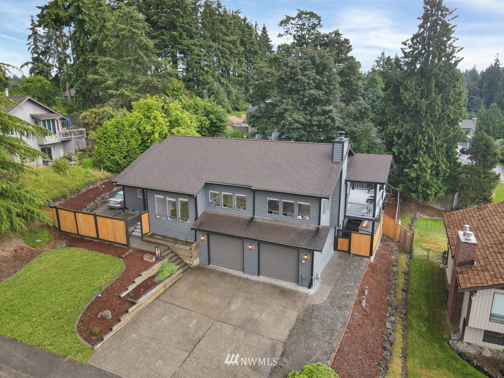 aerial view of a house with a yard and deck