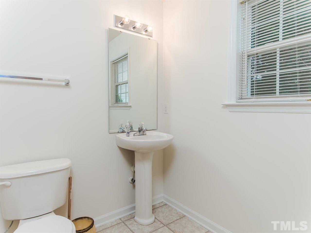 4720 Drewbridge Way Raleigh, NC 27604 - Photo 13 of 21 a bathroom with a sink toilet and mirror