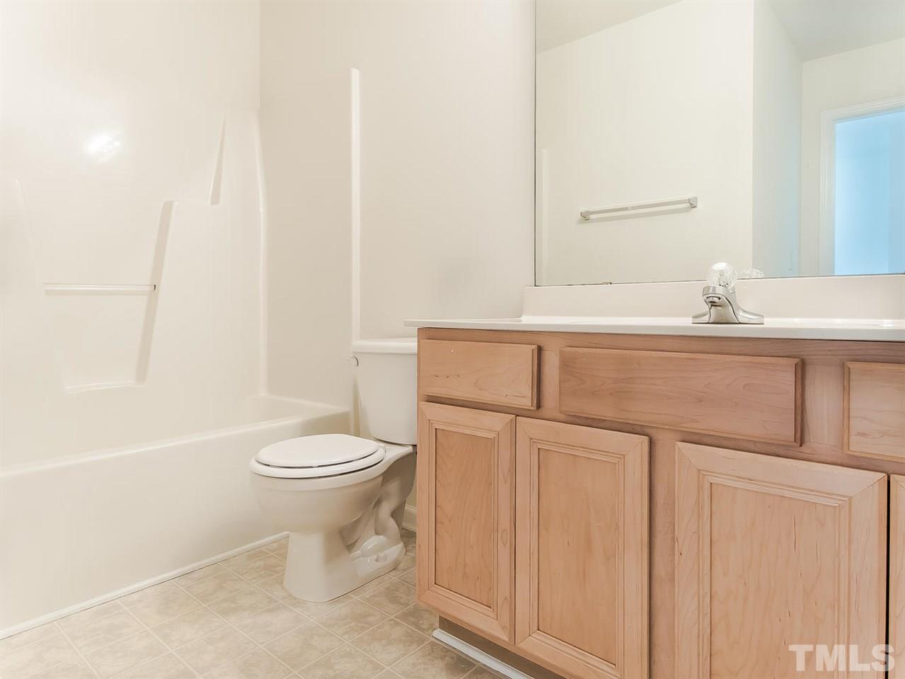 4720 Drewbridge Way Raleigh, NC 27604 - Photo 16 of 21 a bathroom with a sink a toilet and shower