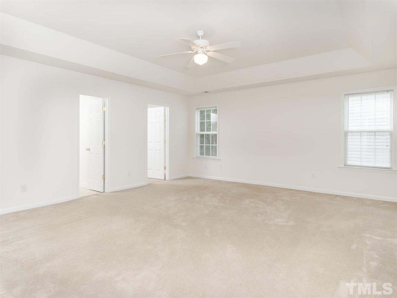 4720 Drewbridge Way Raleigh, NC 27604 - Photo 17 of 21 an empty room with windows and ceiling fan