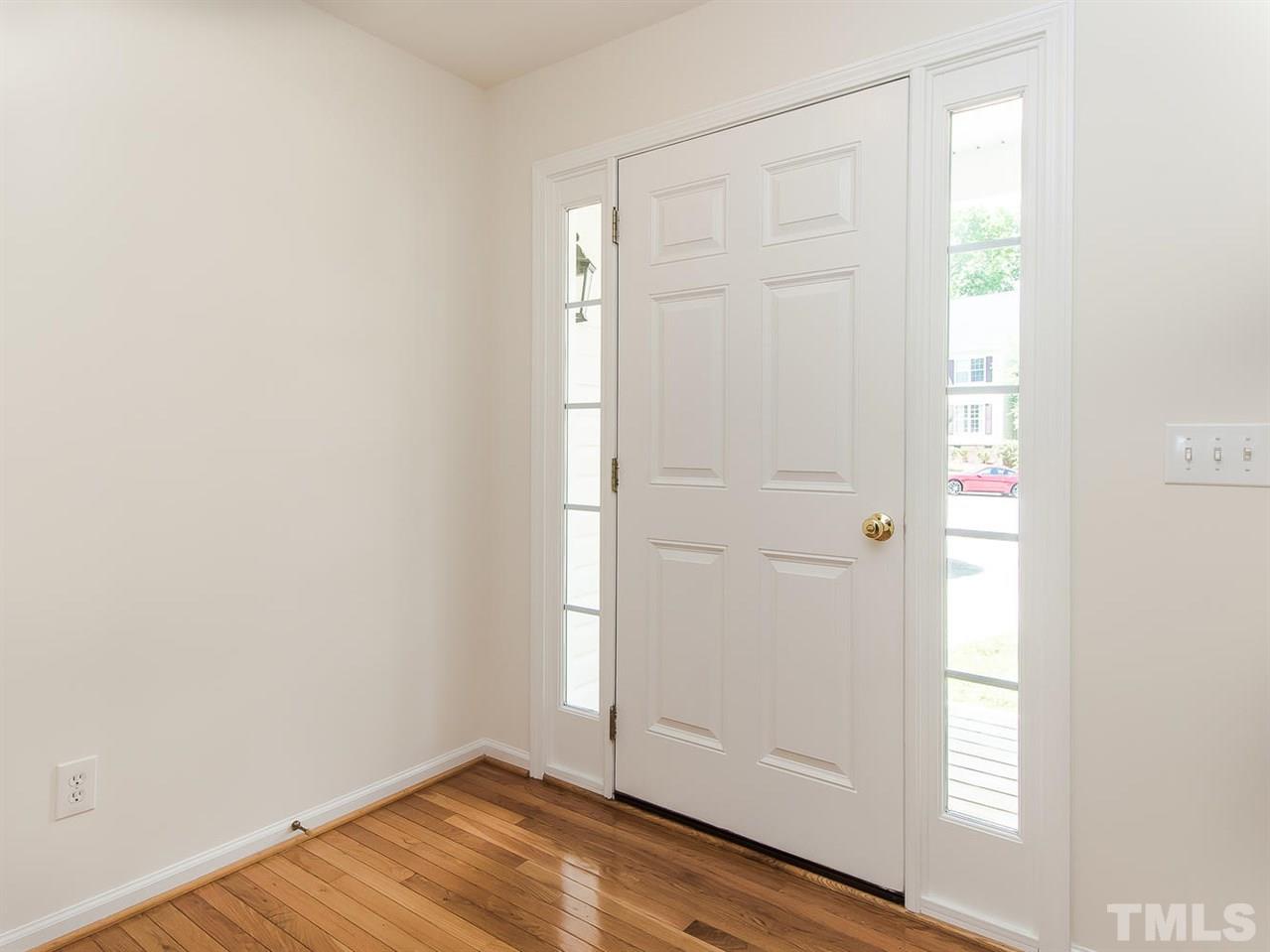 4720 Drewbridge Way Raleigh, NC 27604 - Photo 5 of 21 an empty room with wooden floor and windows