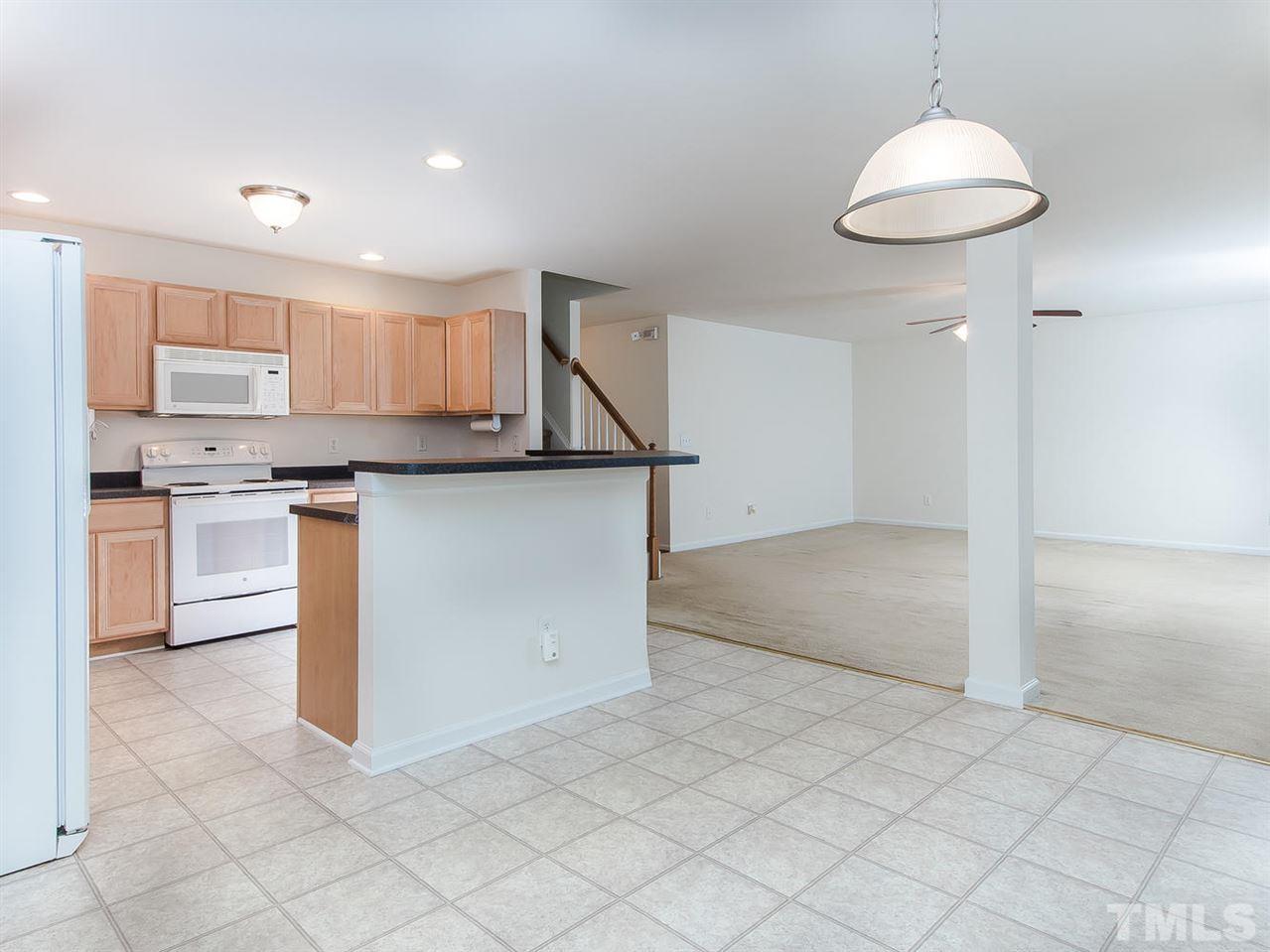 4720 Drewbridge Way Raleigh, NC 27604 - Photo 8 of 21 a kitchen with stainless steel appliances granite countertop a refrigerator and a sink