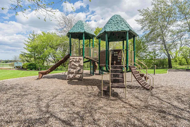 a view of a park with swings and slides