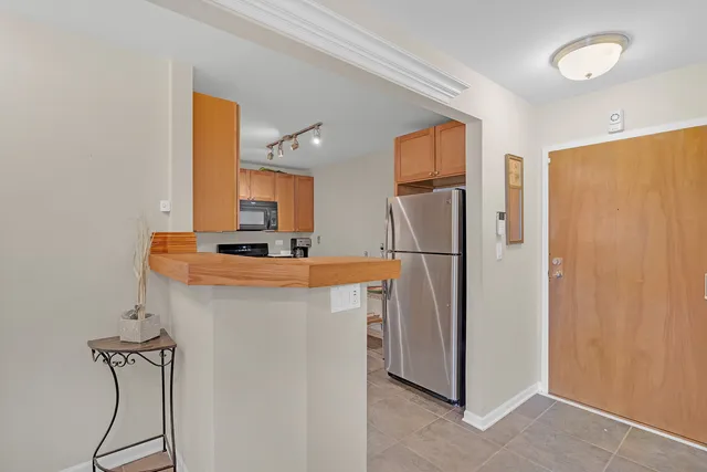 a kitchen with stainless steel appliances a refrigerator and a cabinets