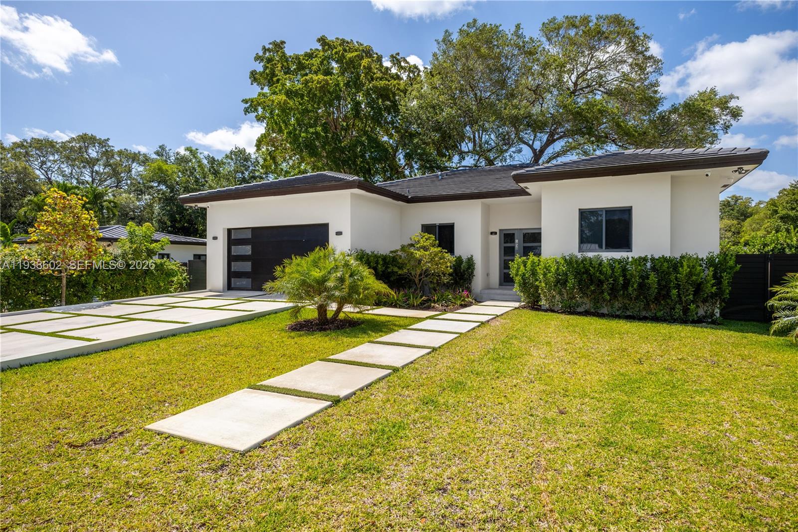 1030 Northeast 121st Street Biscayne Park, FL 33161 - Photo 1 of 47 a view of a house with pool and a yard