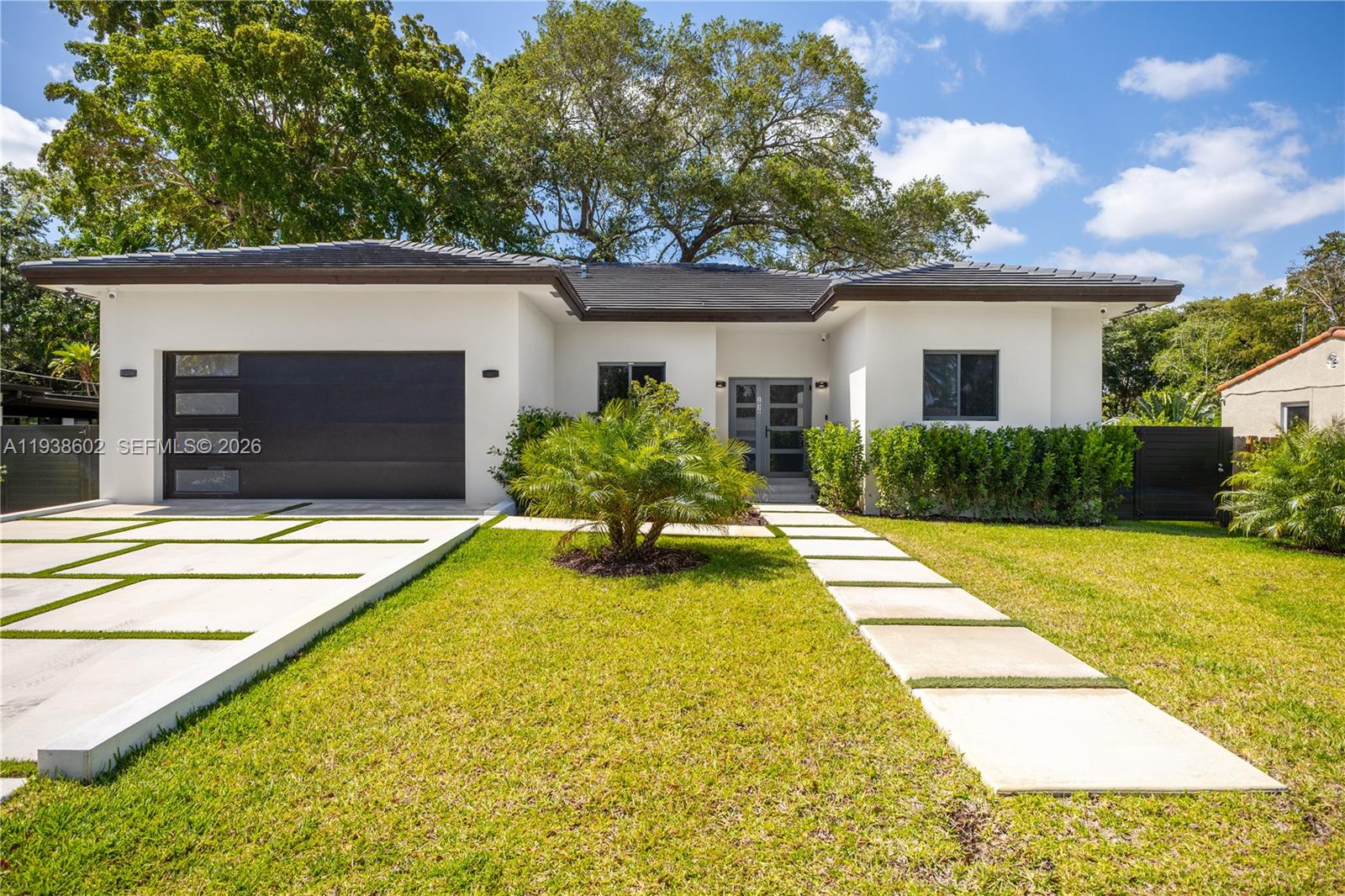 1030 Northeast 121st Street Biscayne Park, FL 33161 - Photo 2 of 47 a view of a backyard with a swimming pool