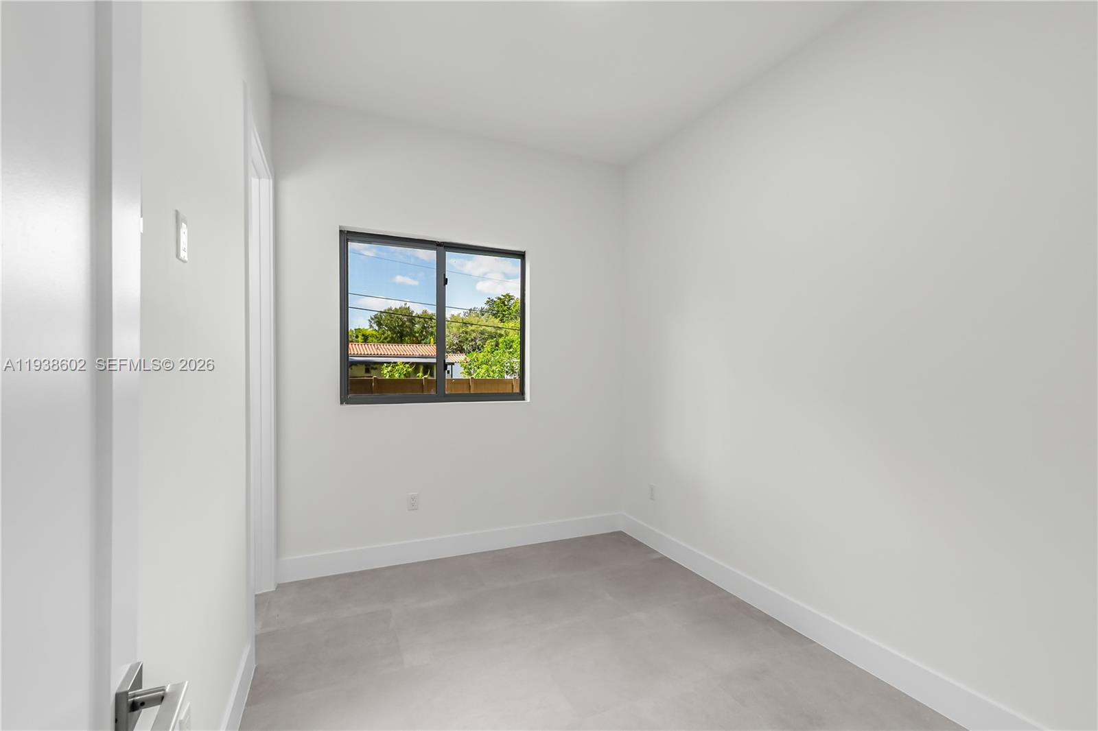 1030 Northeast 121st Street Biscayne Park, FL 33161 - Photo 29 of 47 a view of an empty room with a window
