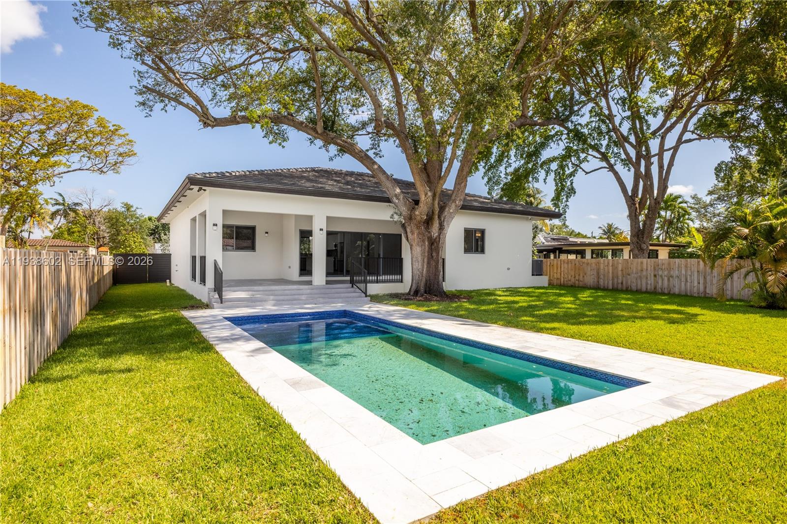 1030 Northeast 121st Street Biscayne Park, FL 33161 - Photo 3 of 47 a view of a house with swimming pool and a yard