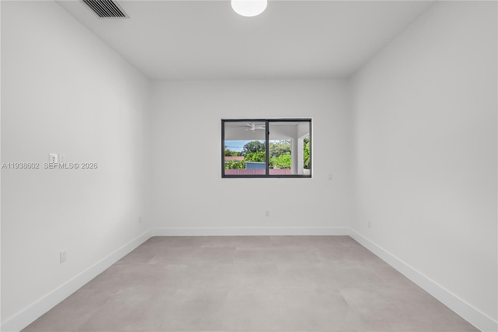 1030 Northeast 121st Street Biscayne Park, FL 33161 - Photo 31 of 47 an empty room with a window