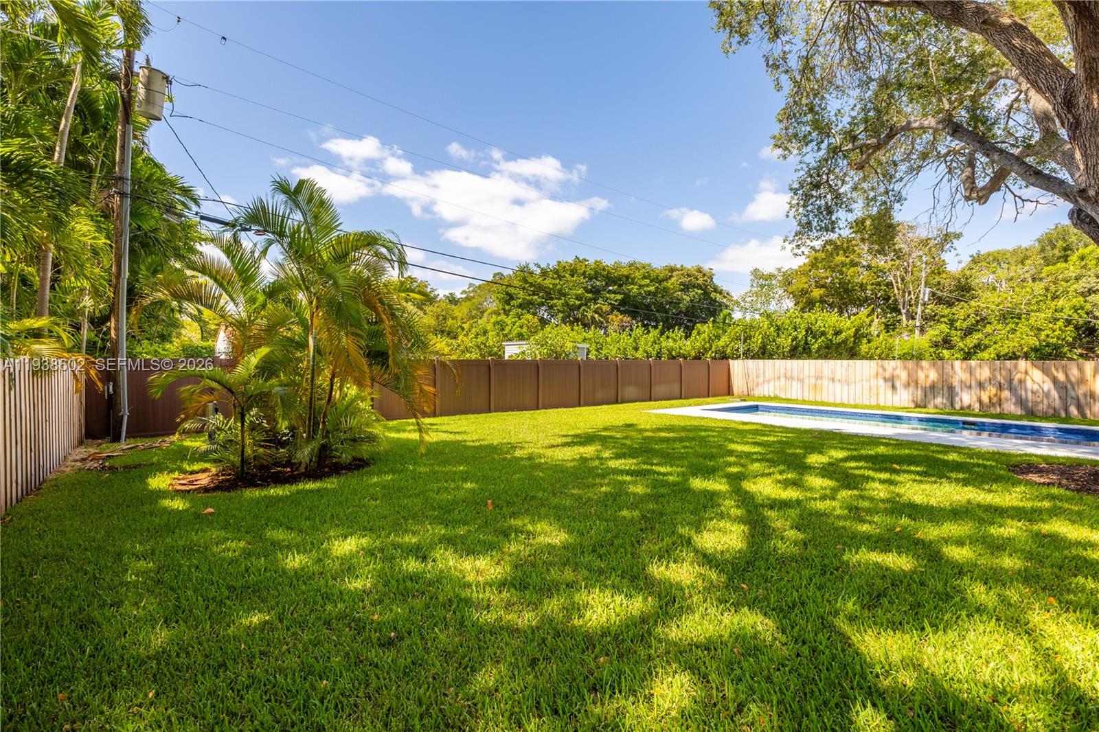 1030 Northeast 121st Street Biscayne Park, FL 33161 - Photo 44 of 47 a view of yard with swimming pool and green space