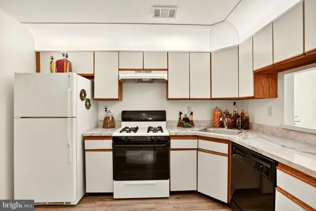 a kitchen with stainless steel appliances a sink stove and cabinets