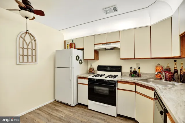 a view of a hallway with entryway wooden floor and dining room view