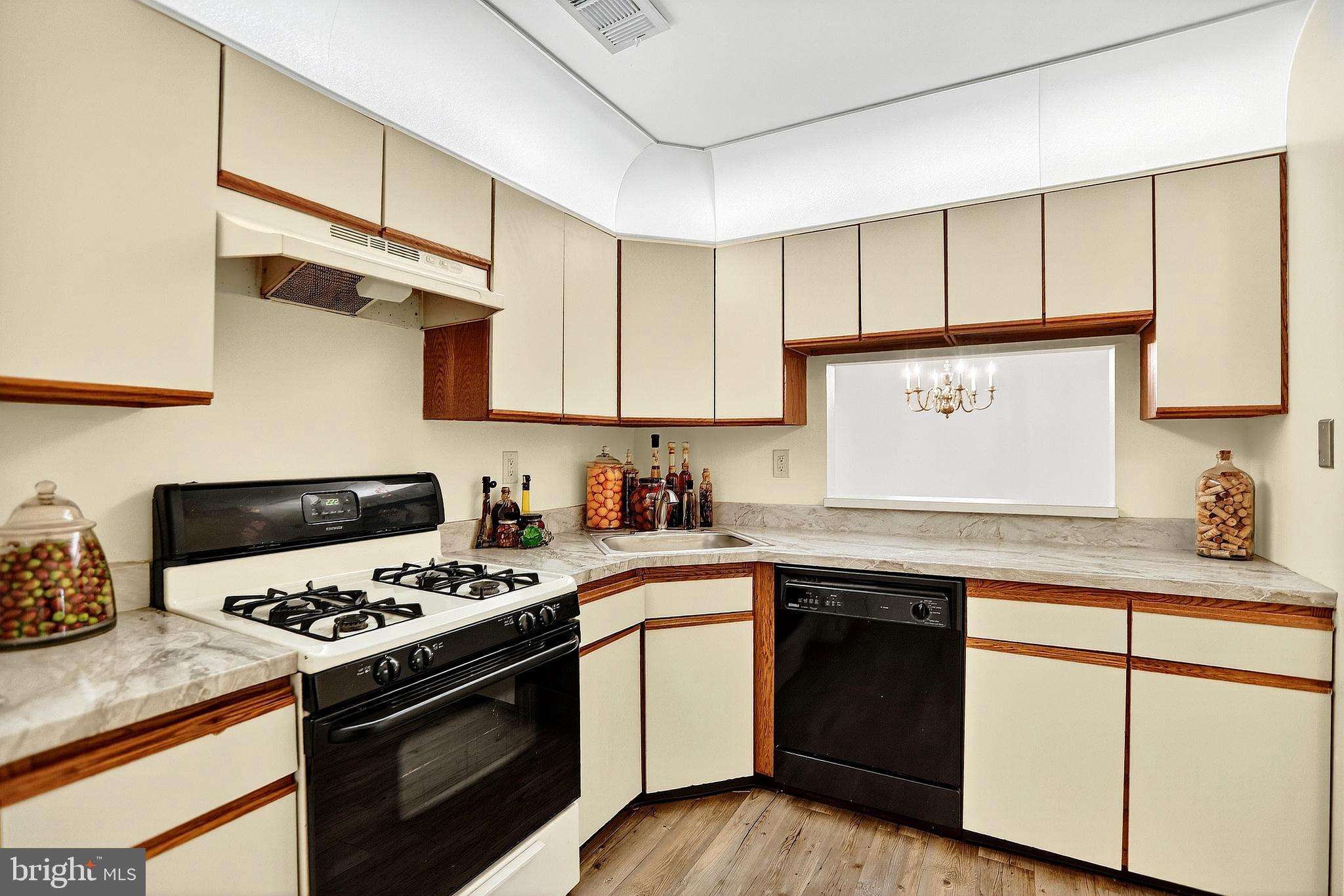 13 Azalea Court Lawrenceville, NJ 08648 - Photo 13 of 27 a kitchen with stainless steel appliances a sink stove and cabinets