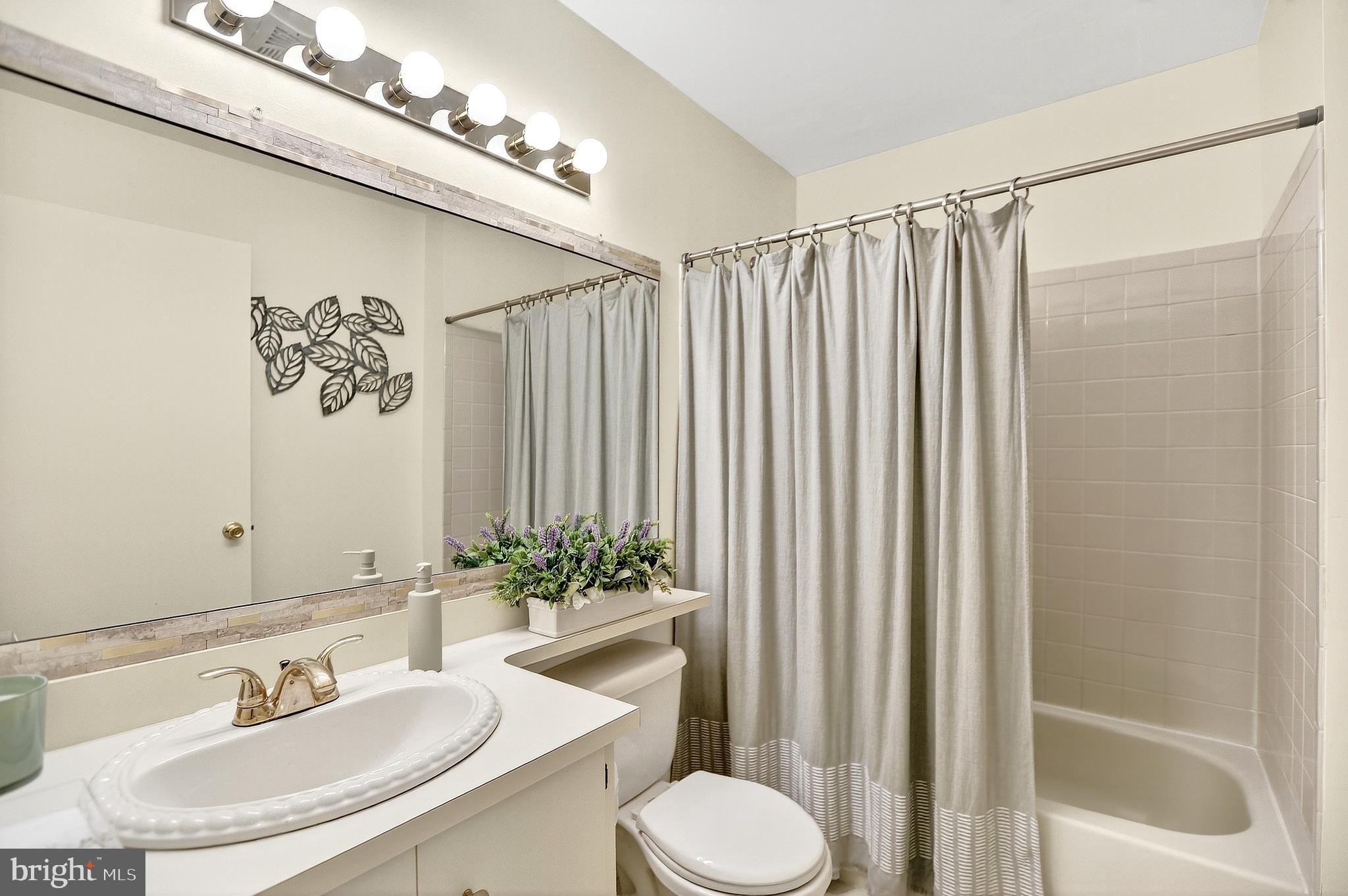 13 Azalea Court Lawrenceville, NJ 08648 - Photo 20 of 27 a bathroom with a sink and a mirror