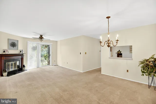 a view of a livingroom with a fireplace and chandelier