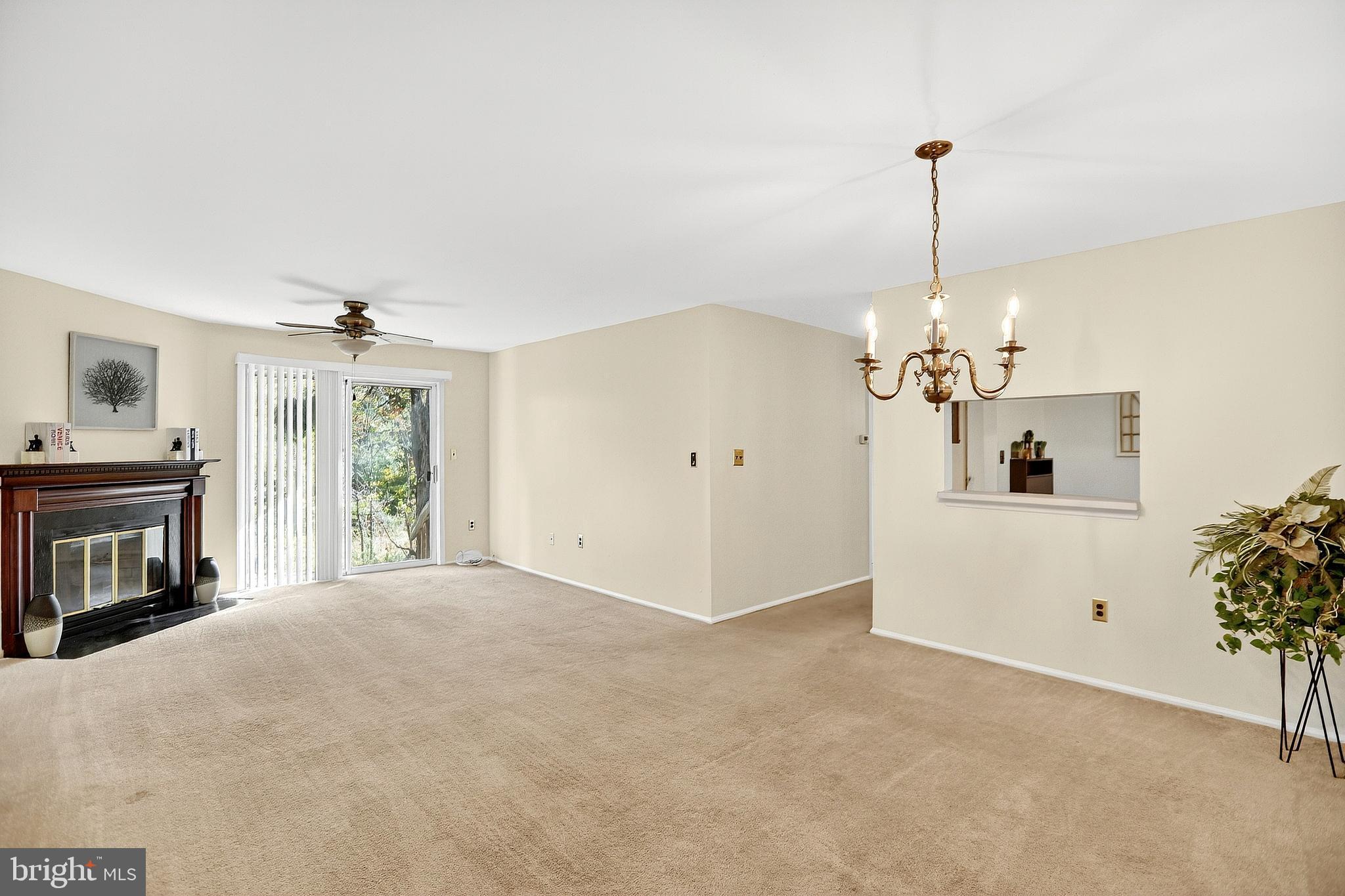 13 Azalea Court Lawrenceville, NJ 08648 - Photo 5 of 27 a view of a livingroom with a fireplace and chandelier