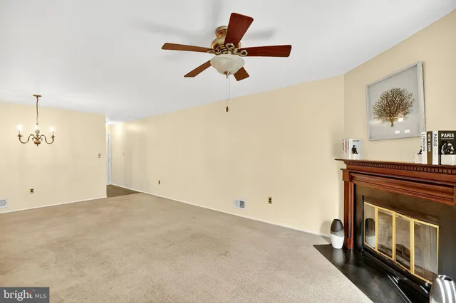 a view of a livingroom with a fireplace and a window