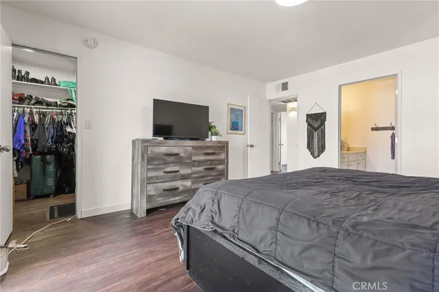 a bedroom with a bed and a flat screen television