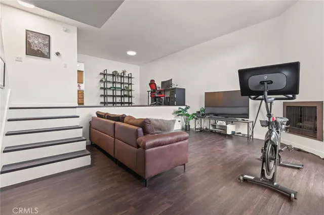 a living room with furniture gym equipment and a large window