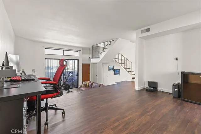 a view of a room with furniture and a window