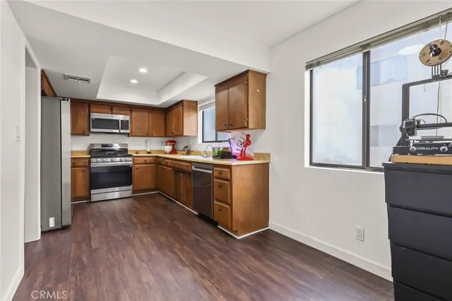 a kitchen with a sink cabinets and wooden floor