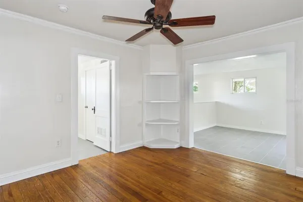 a view of empty room with wooden floor