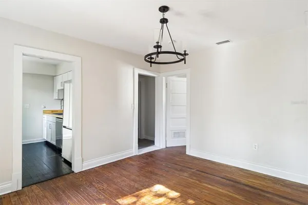 a view of a room with wooden floor and carpet