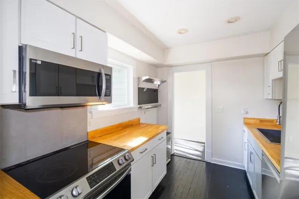 a kitchen with a sink and a microwave