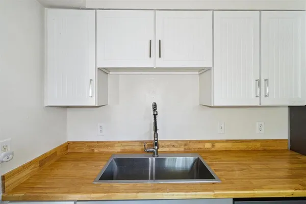 a kitchen with a sink cabinets and appliances