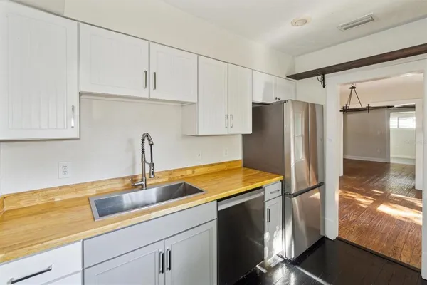 a kitchen with stainless steel appliances granite countertop a refrigerator and a sink