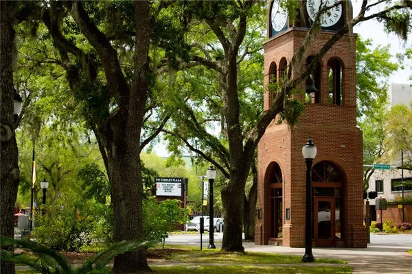 a view of a lake with a big yard and large trees