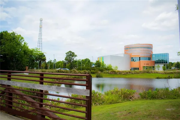 a front view of a house with a yard and lake view