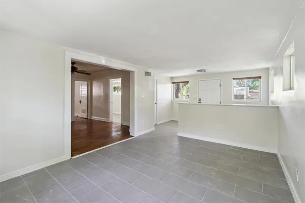 an empty room with windows and entrance