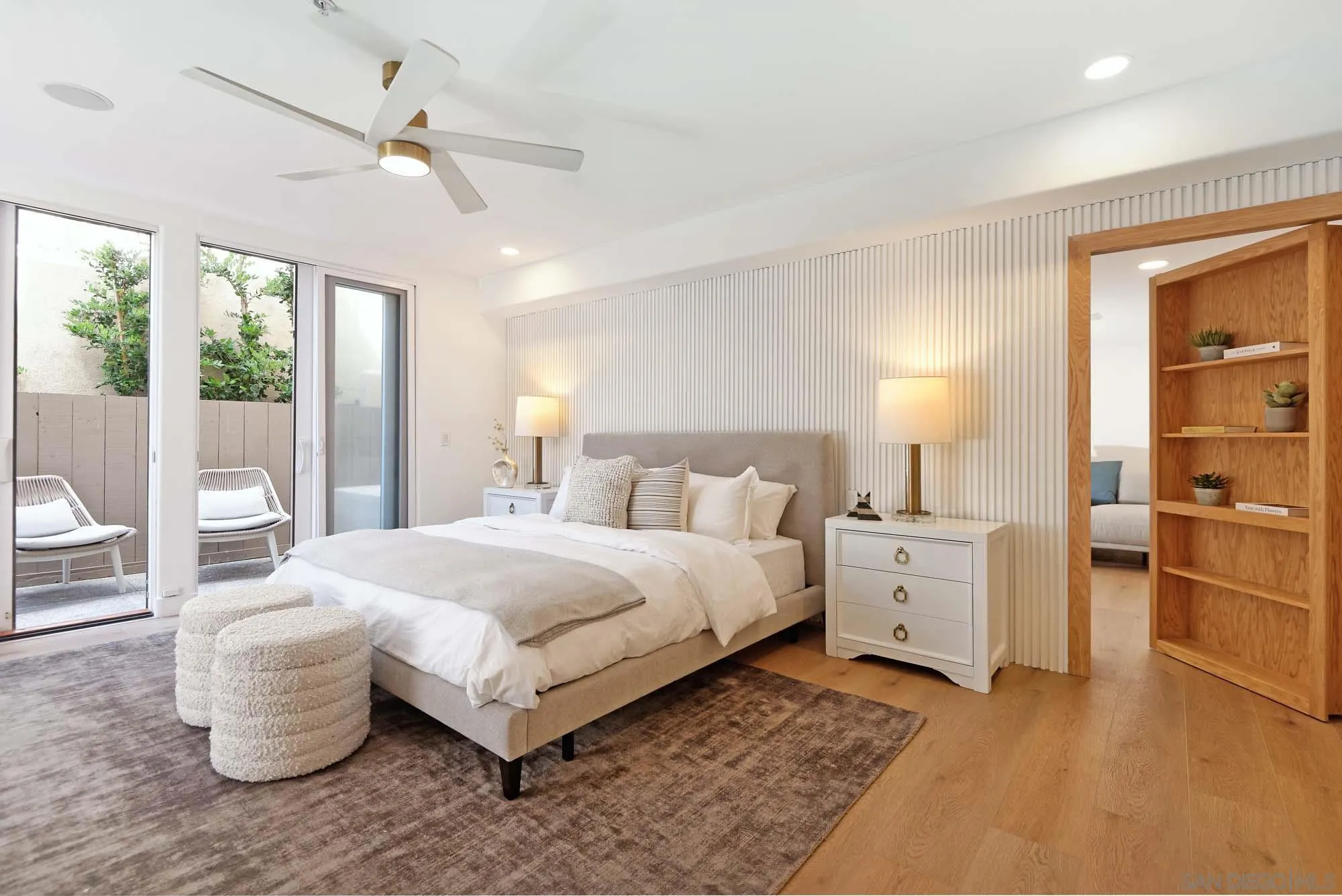 302 Prospect Street, Unit 6 La Jolla, CA 92037 - Photo 12 of 28 a bedroom with a large bed and a chandelier