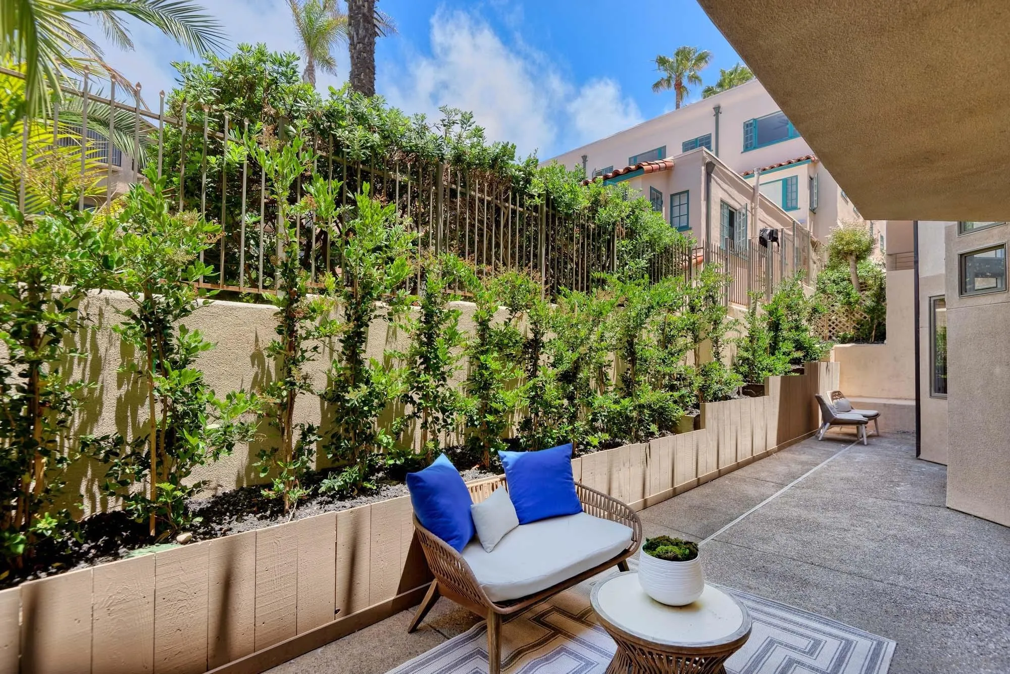 302 Prospect Street, Unit 6 La Jolla, CA 92037 - Photo 14 of 28 a view of a chair and table in the back yard of the house