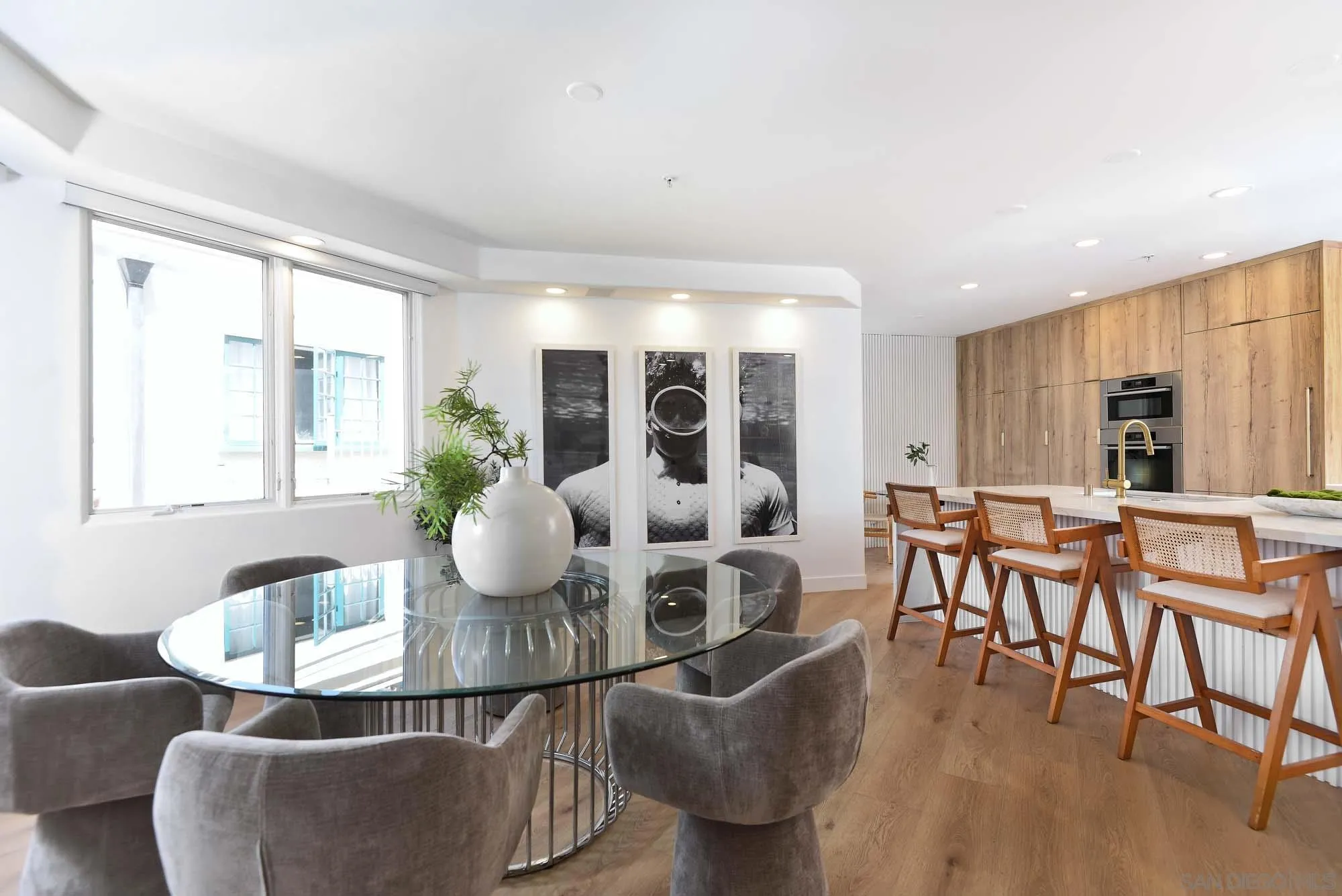 302 Prospect Street, Unit 6 La Jolla, CA 92037 - Photo 7 of 28 a view of a dining room with furniture and wooden floor
