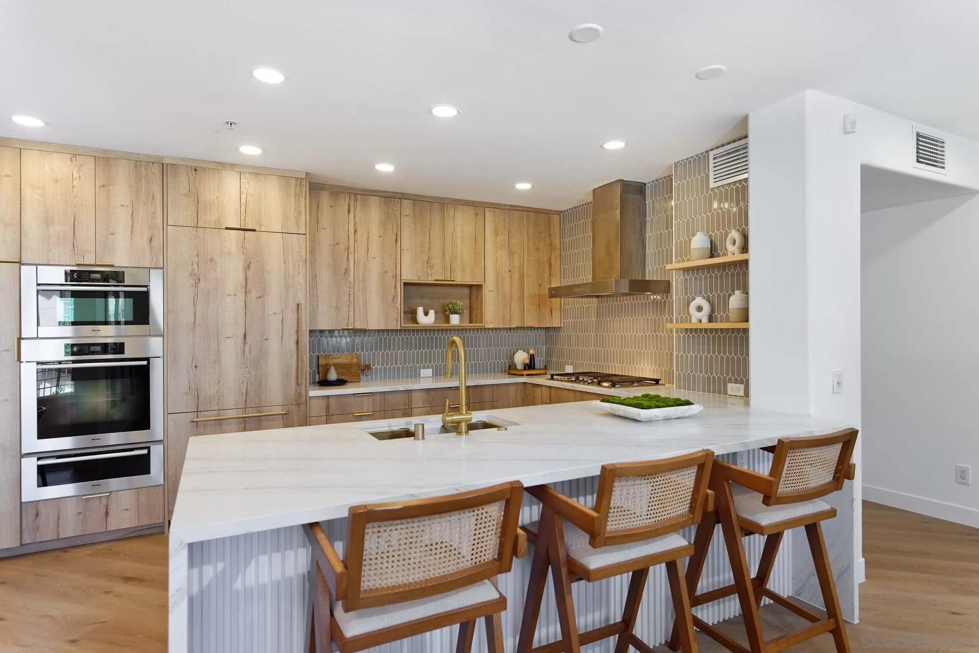 302 Prospect Street, Unit 6 La Jolla, CA 92037 - Photo 8 of 28 a kitchen with stainless steel appliances granite countertop a table chairs sink refrigerator and microwave