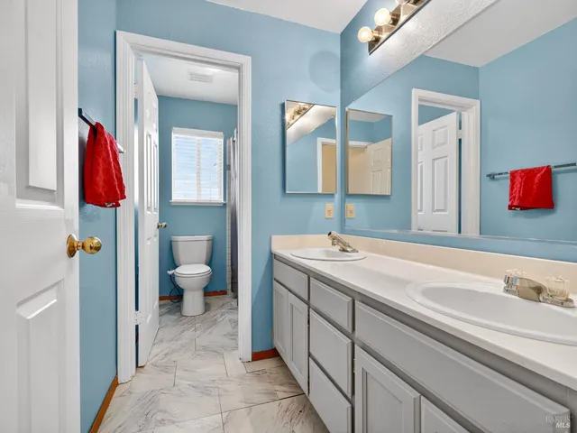 a room with a dresser with windows