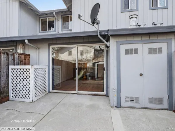 a view of backyard of house with wooden fence