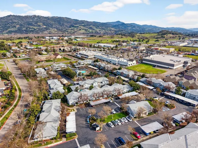 an aerial view of residential houses with outdoor space