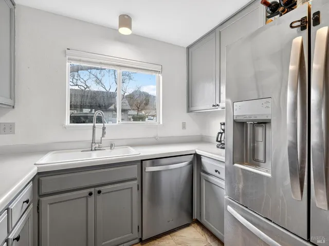 a kitchen with cabinets stainless steel appliances and wooden cabinets