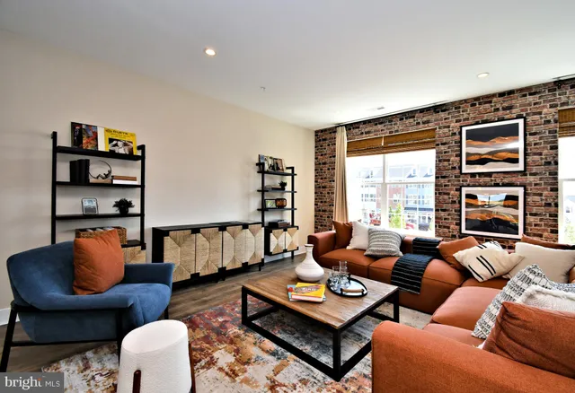 a living room with furniture a rug and a large window